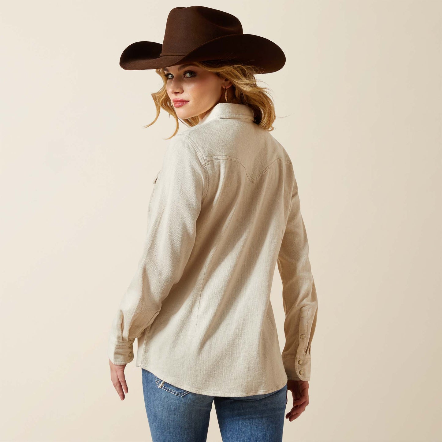 Woman in warm Western shirt and cowboy hat
