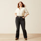 Woman in dark wash jeans and a button-down shirt.
