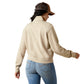 Woman in beige jacket and jeans, back view