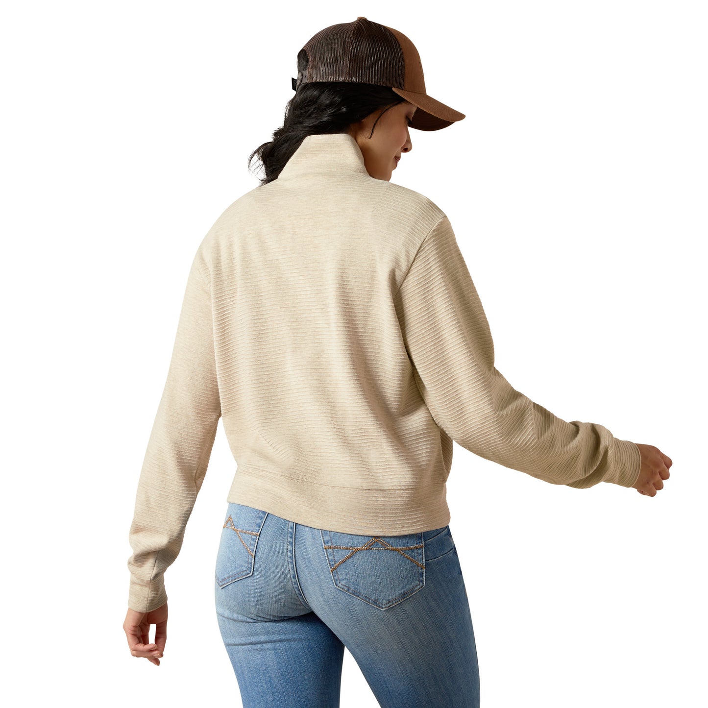 Woman in beige jacket and jeans, back view