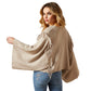 Woman wearing beige fringed sweater, back view
