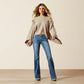 Woman in warm-toned fringed sweater and blue jeans