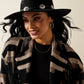 Woman wearing a warm patterned jacket and hat