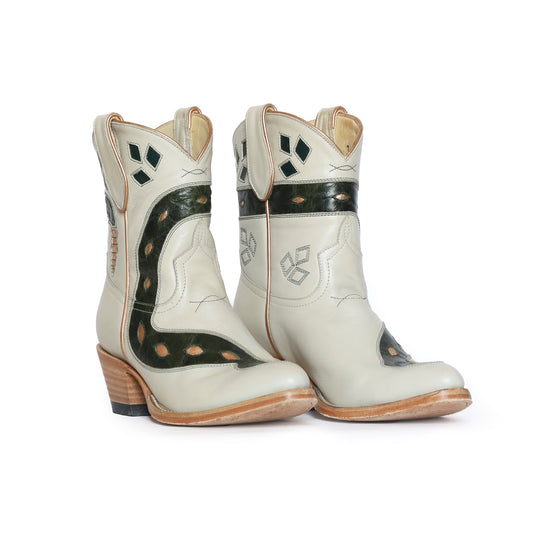 Off-white leather cowboy boots with green accents