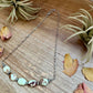 Necklace with beads on wood surface