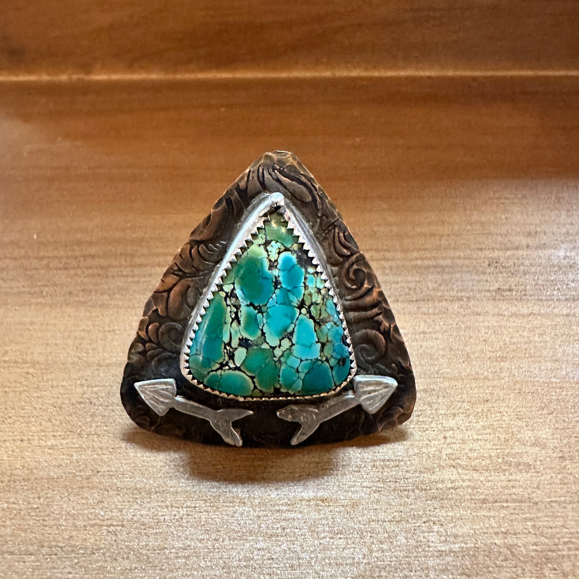 Turquoise stone ring with arrow accents.