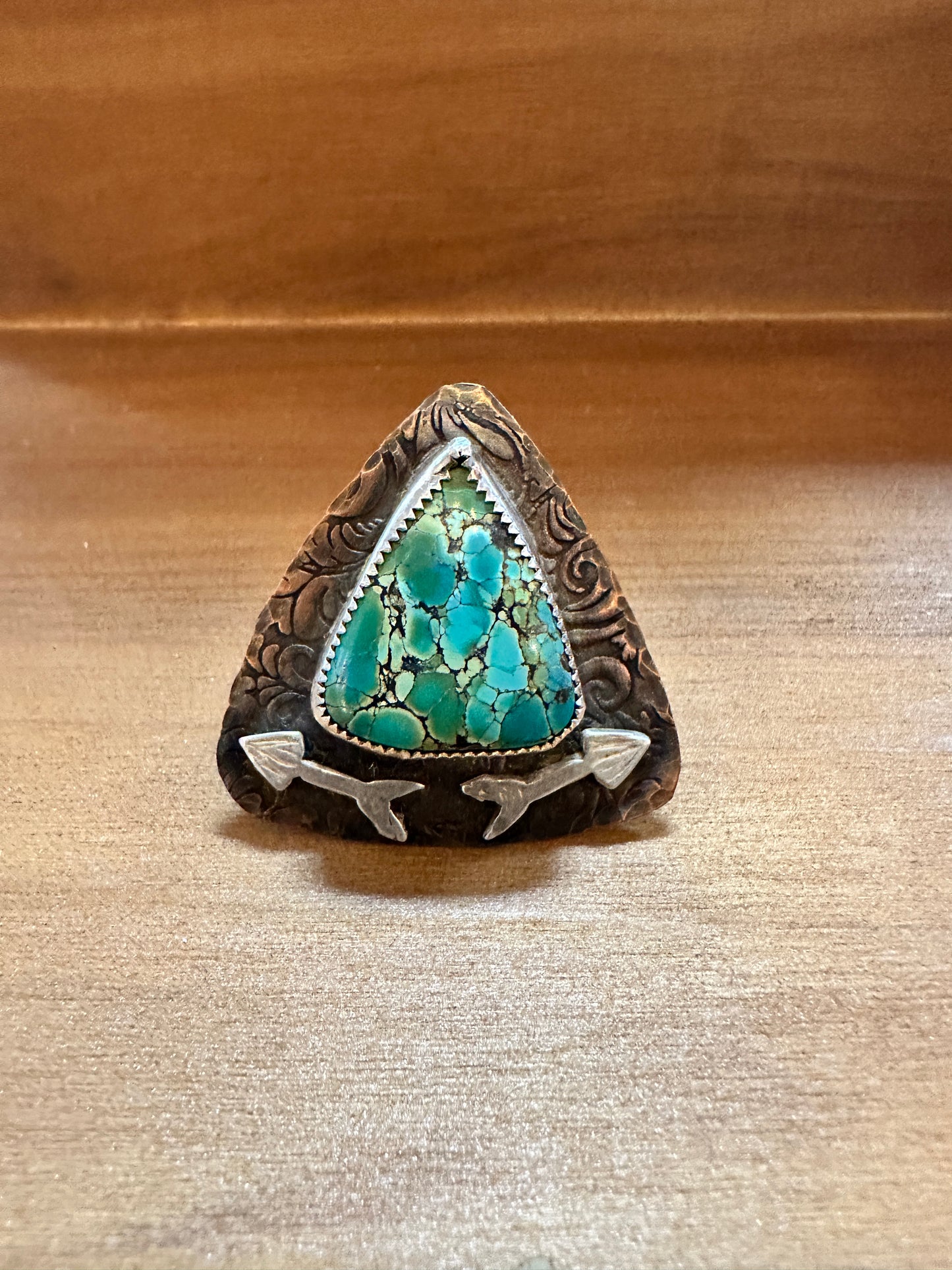 Turquoise stone ring with arrow accents.