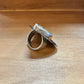 Silver ring with green stone.