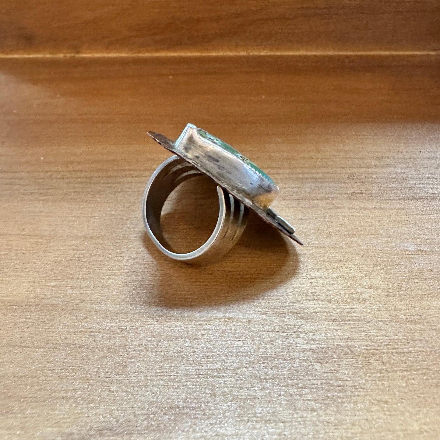 Silver ring with green stone.