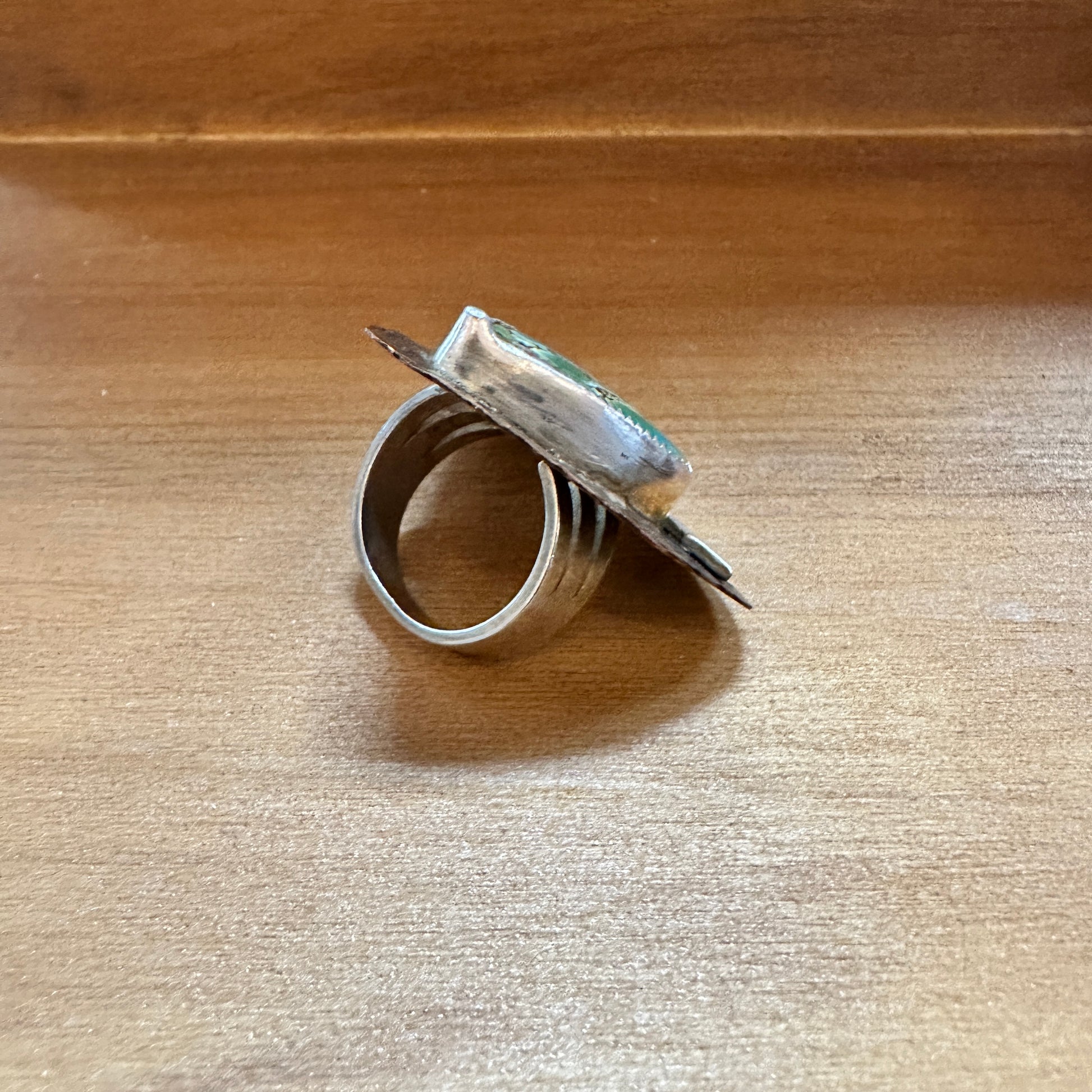Silver ring with green stone.