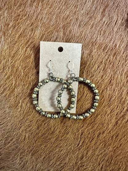 Hoop earrings with small beads on display card.