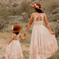 Woman and child in matching dresses and hats.
