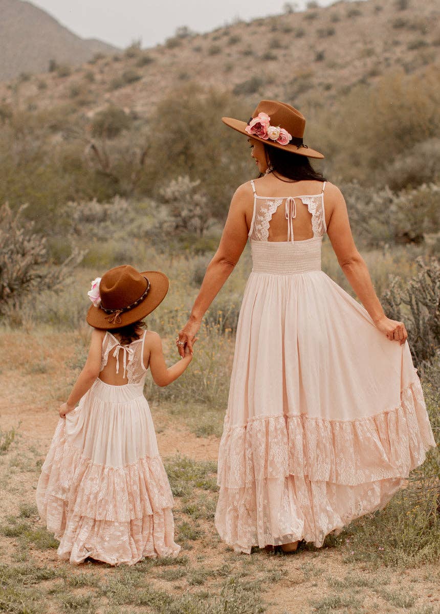 Woman and child in matching dresses and hats.
