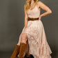 Woman in pink dress and boots.