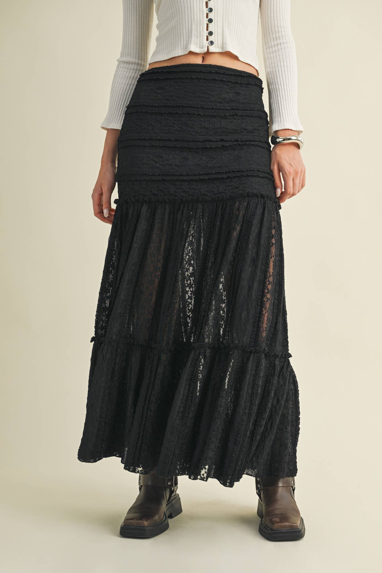 Woman in black lace skirt and boots.