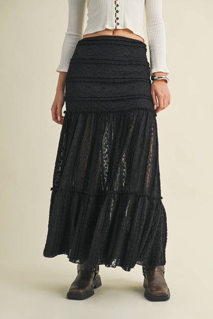 Woman in black lace skirt and boots.