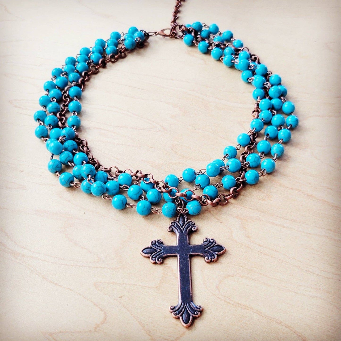 Turquoise beaded necklace with cross pendant.