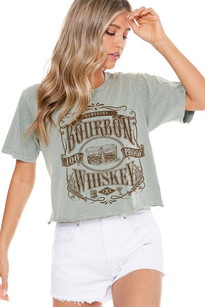 Woman in green t-shirt and white shorts.