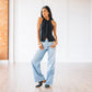 Woman in black Robinslingback mule, jet black top and jeans