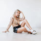 Woman wearing Robin Mule top & leather shorts