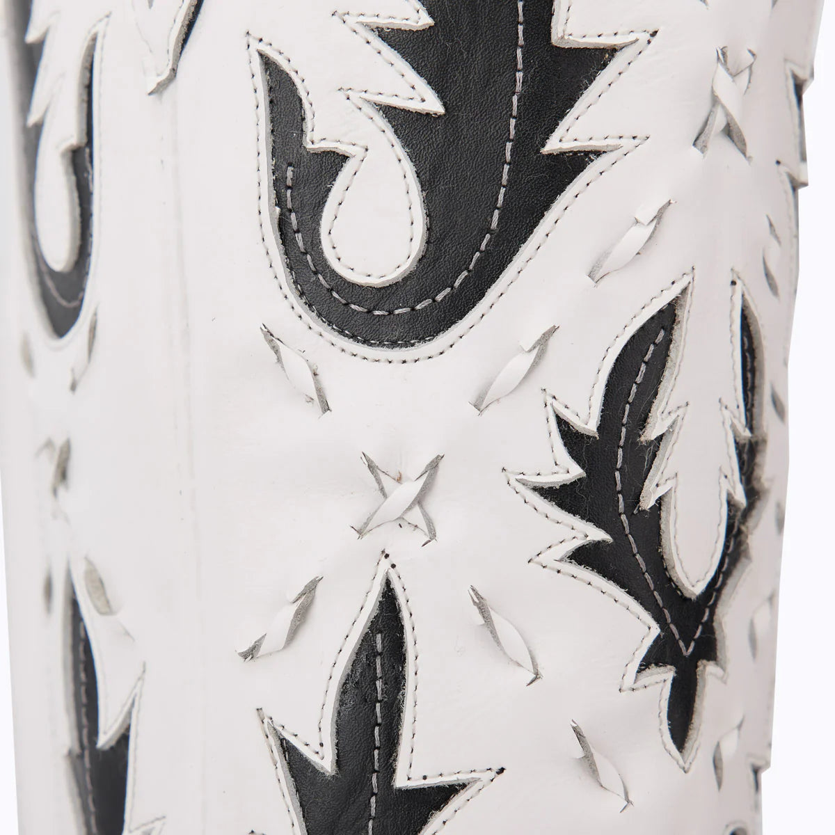 White & black cutout boot, Reverie newsprint design