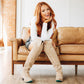 Woman in Lexington OTK latte boots smiling on couch