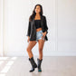 Woman in jet black blazer and Sandaga boots
