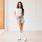 Woman in white top, jean shorts & white/pink cowboy boots