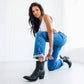 Woman in black Chelsea boots and jeans