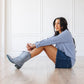 Woman in washed denim midi with grey cowboy boots
