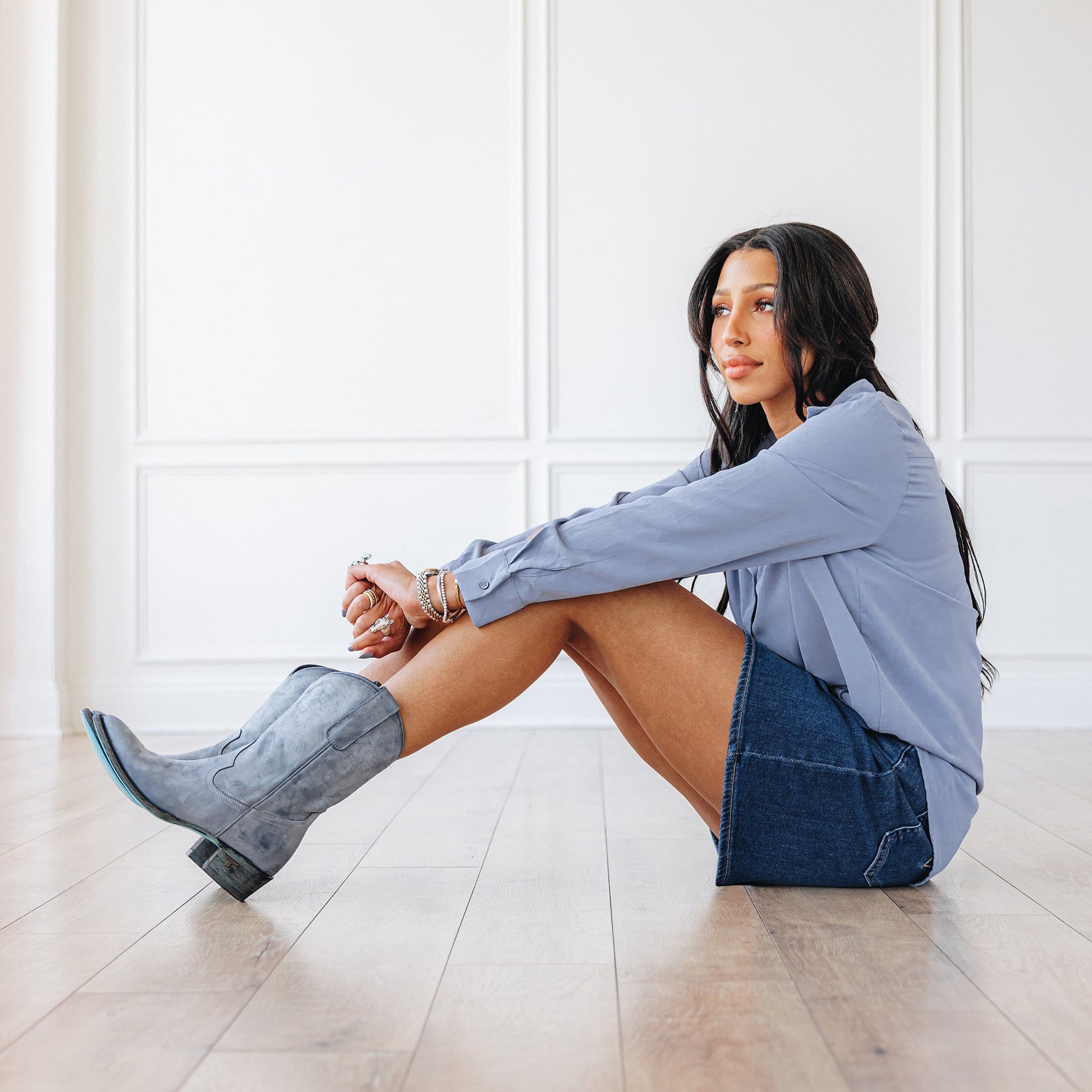 Woman in washed denim midi with grey cowboy boots