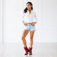 Woman in ruby boots and denim shorts