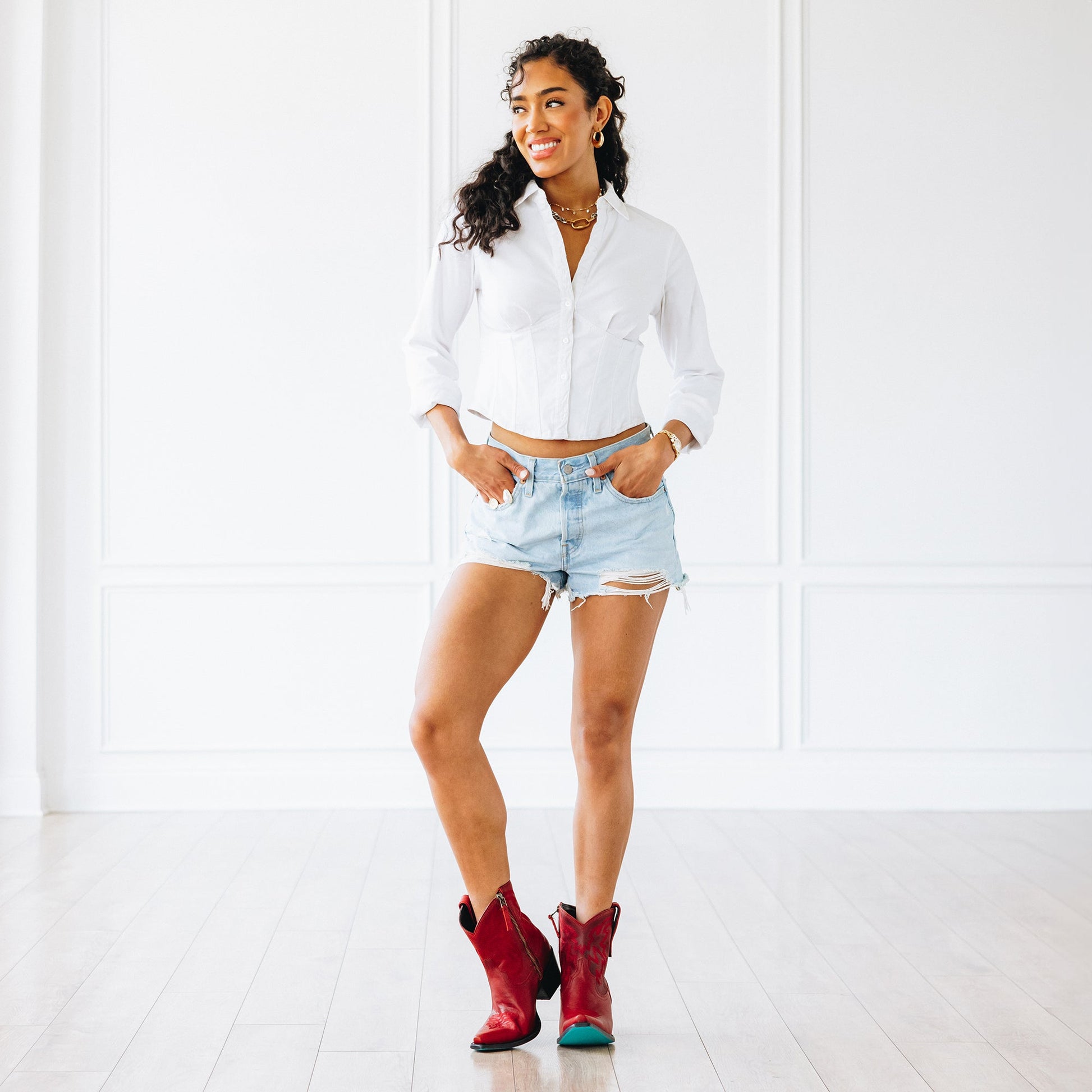 Woman in ruby boots and denim shorts