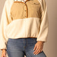 Woman wearing cream and tan fleece pullover