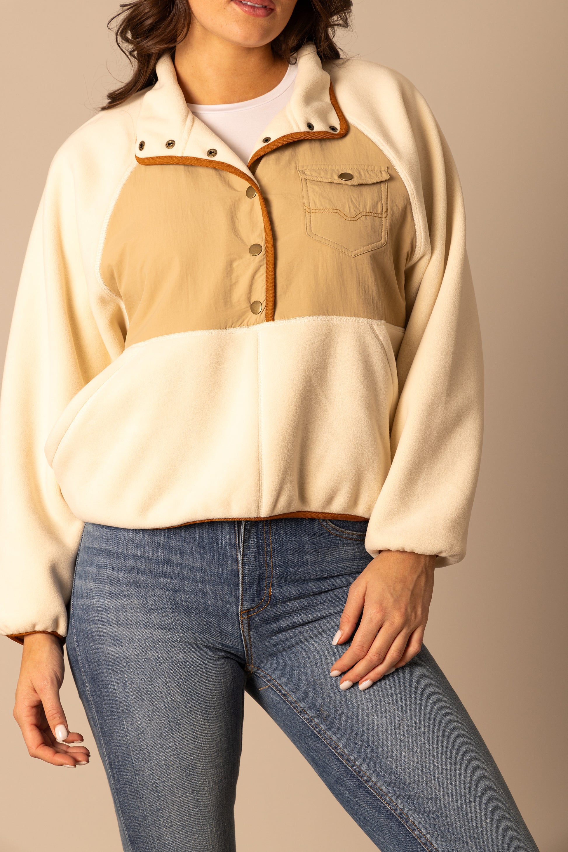 Woman wearing cream and tan fleece pullover