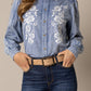 Woman in denim shirt with floral embroidery, unnamed-187