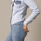 Woman wearing a denim shirt and jeans