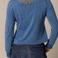 Woman in blue shirt with embroidered design, unnamed-196.