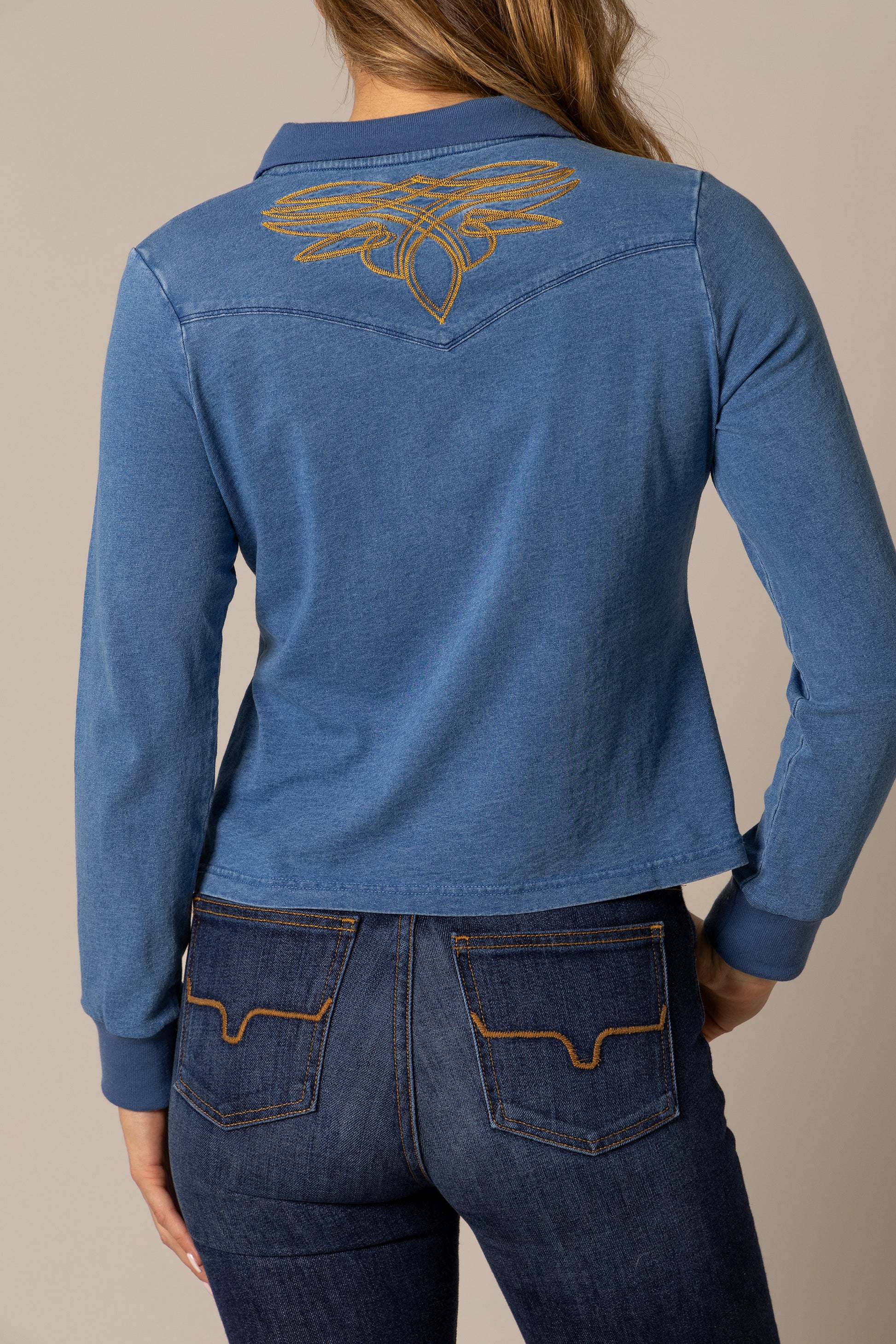 Woman in blue shirt with embroidered design, unnamed-196.