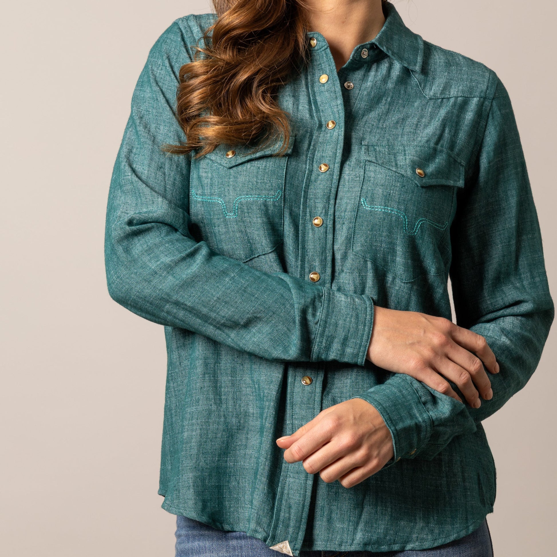 Woman wearing teal shirt
