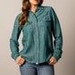 Woman in teal denim shirt and jeans