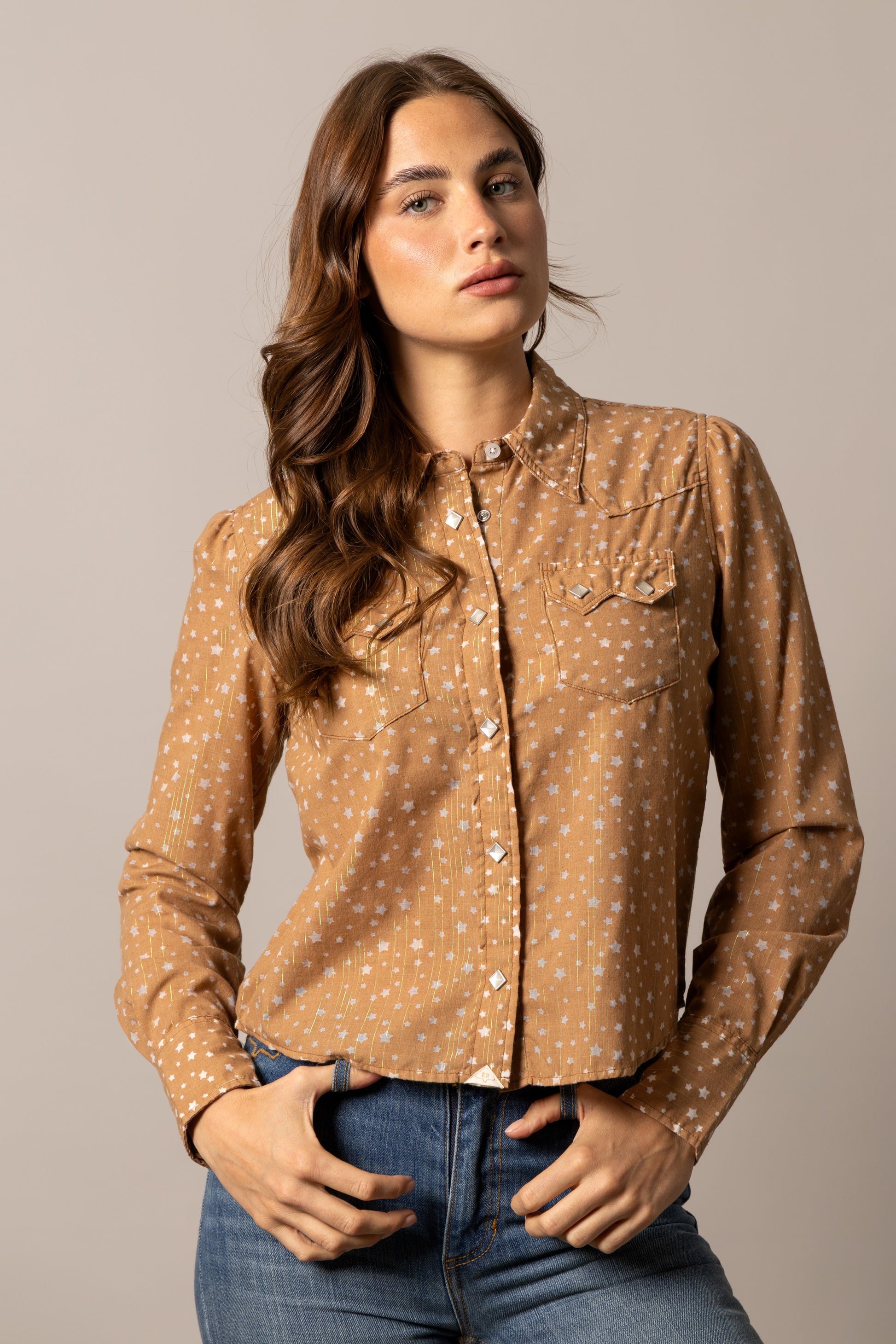 Woman in unnamed-229 tan button-down shirt.