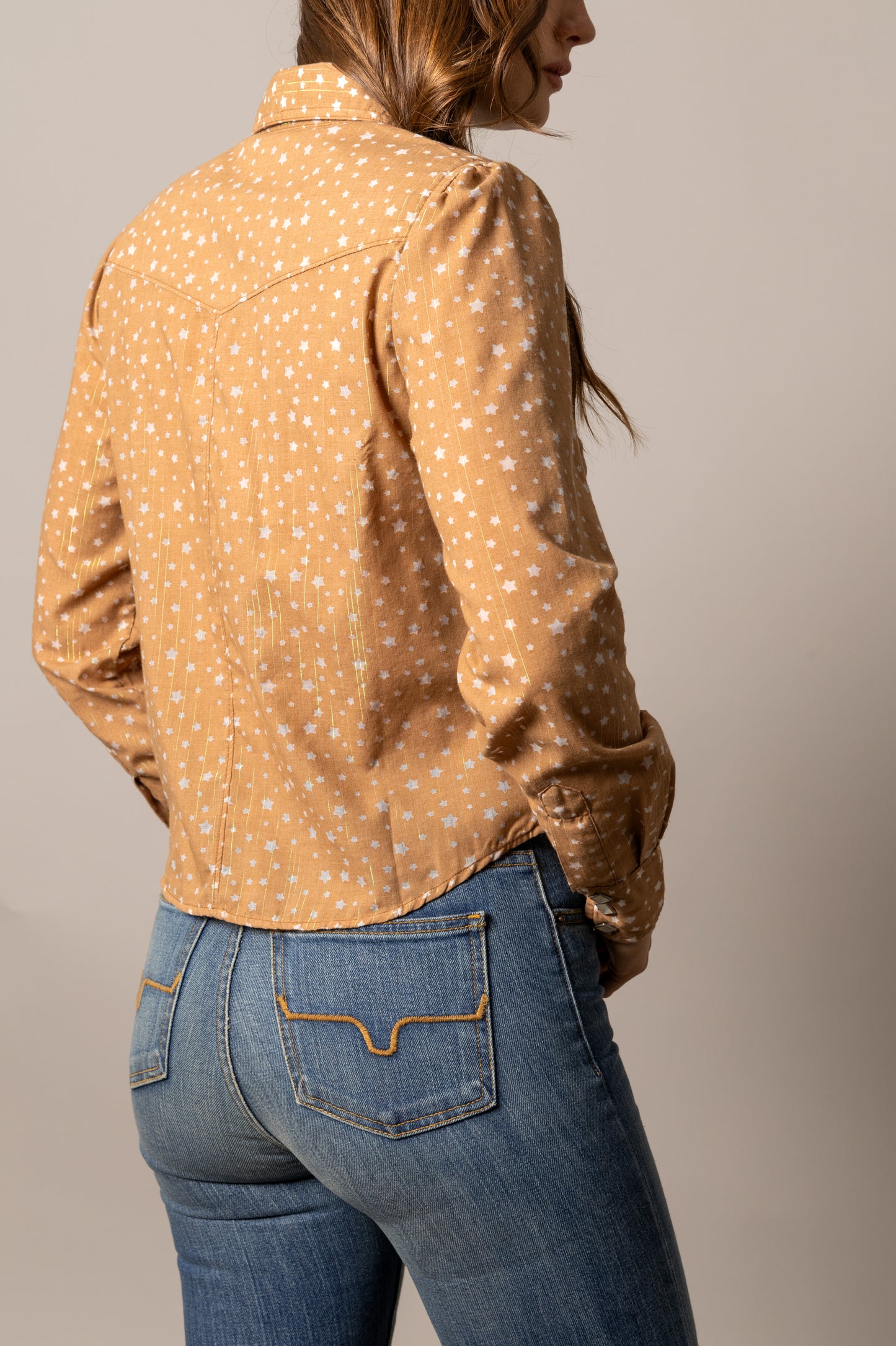 Woman in floral shirt and jeans