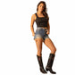 Woman in black tank top, denim shorts, and boots.